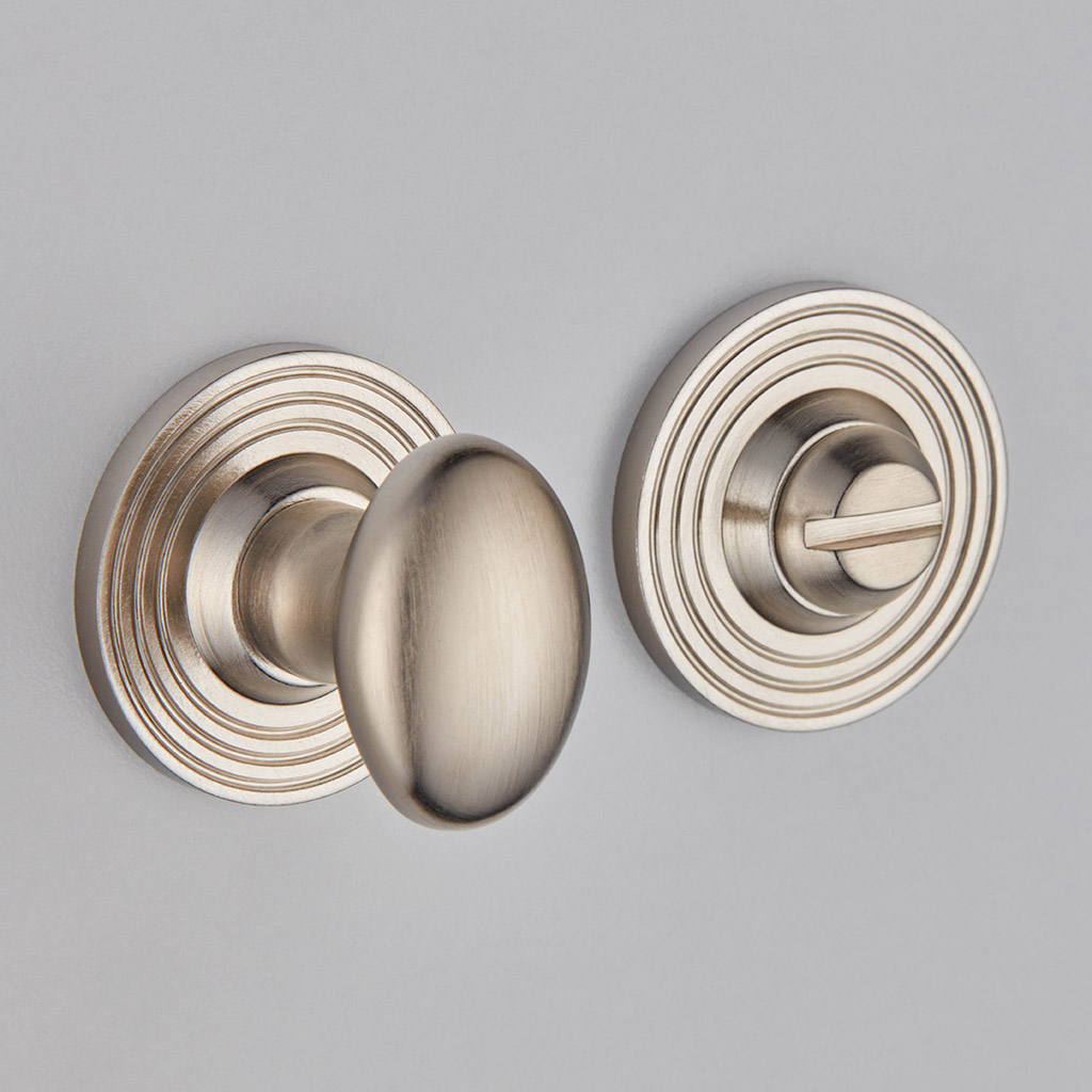 Oval Knob Turn And Release On Reeded Edge Covered Rose